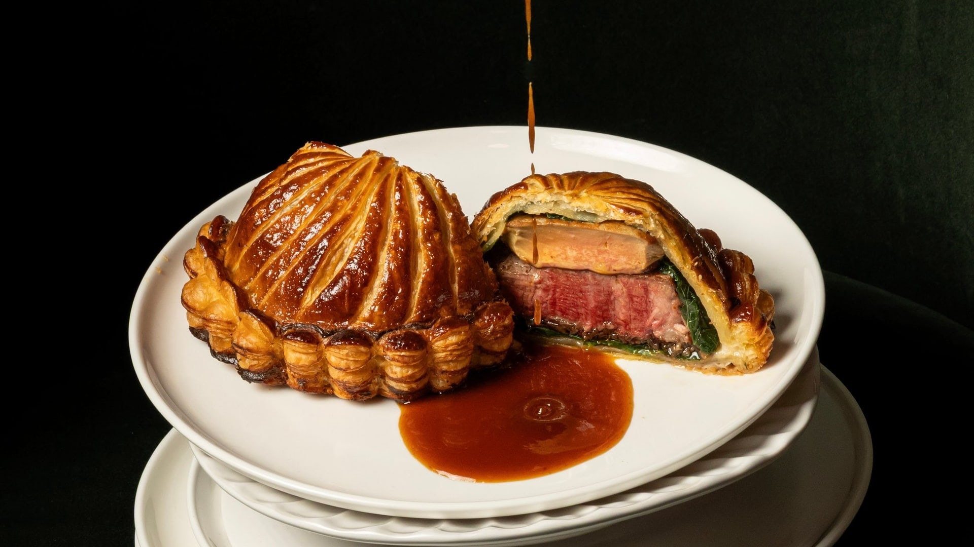 A house beef Wellington carved at the table at Bisou, the modern French restaurant on Soi Langsuan in Bangkok