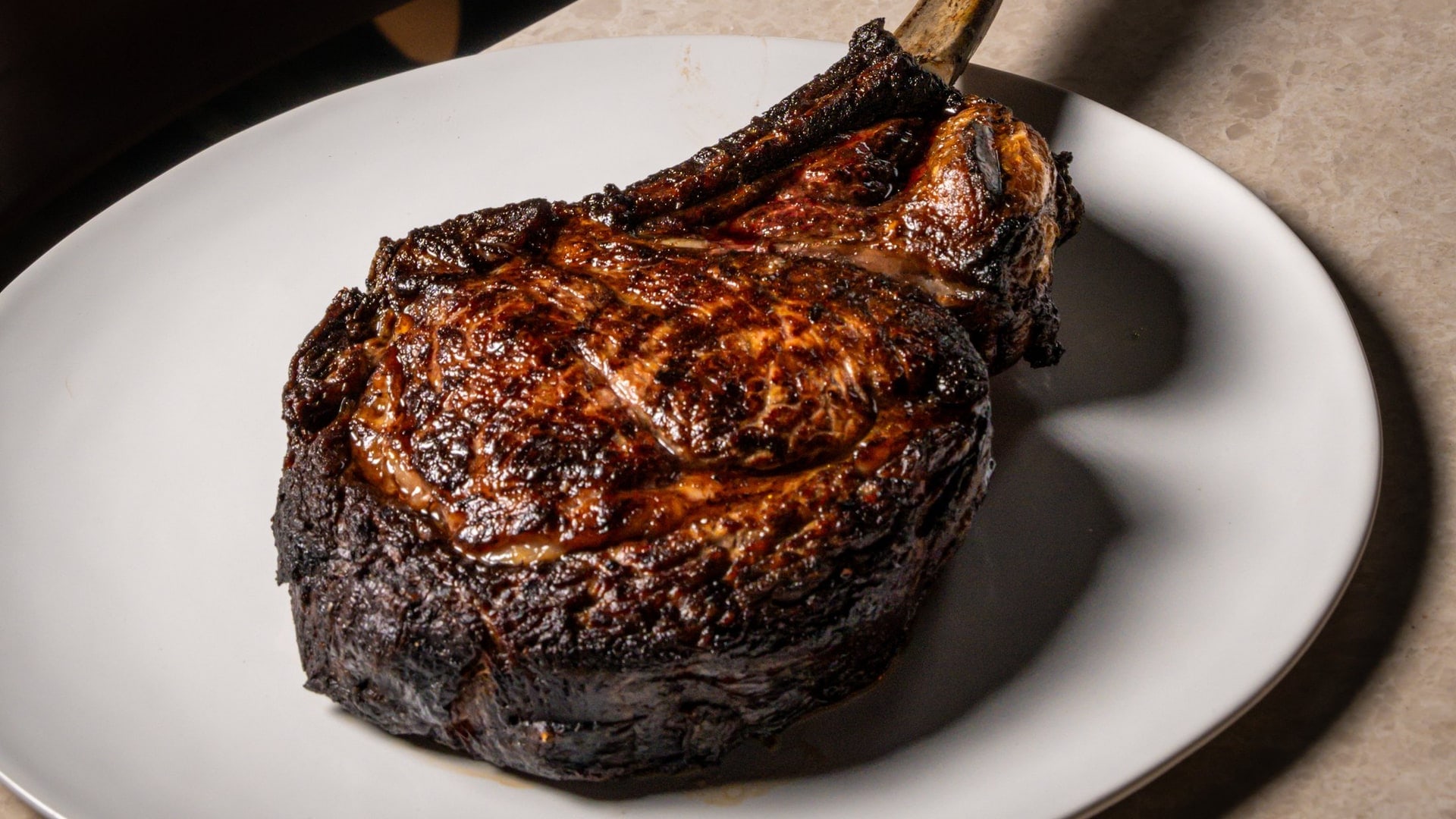 A wood-fired wagyu tomahawk at Bisou, a modern French restaurant on Soi Langsuan in Bangkok