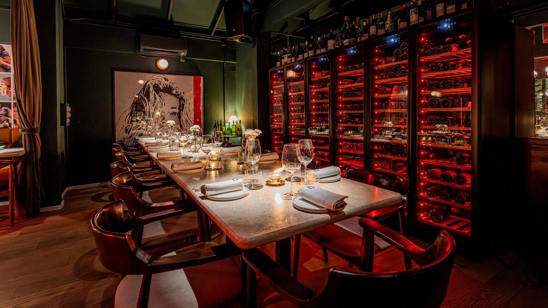 The wine cellar at Bisou, a modern French restaurant on Soi Langsuan in Bangkok, lit in deep red