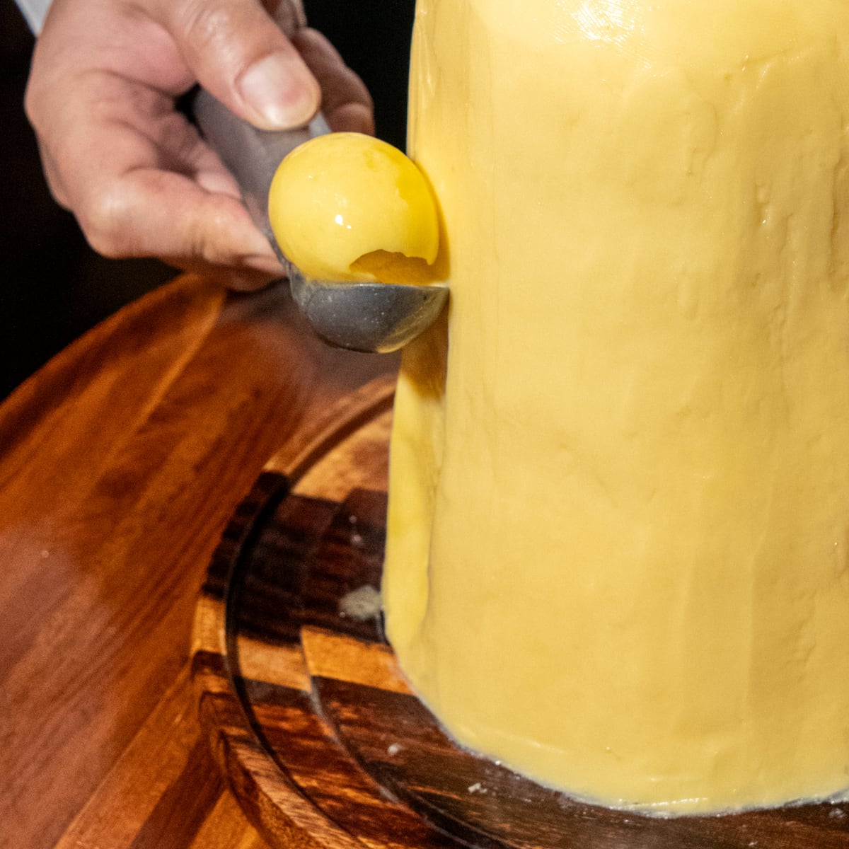 Close-up of a curl of French butter lifted from the block on a warm spoon at Bisou Bangkok