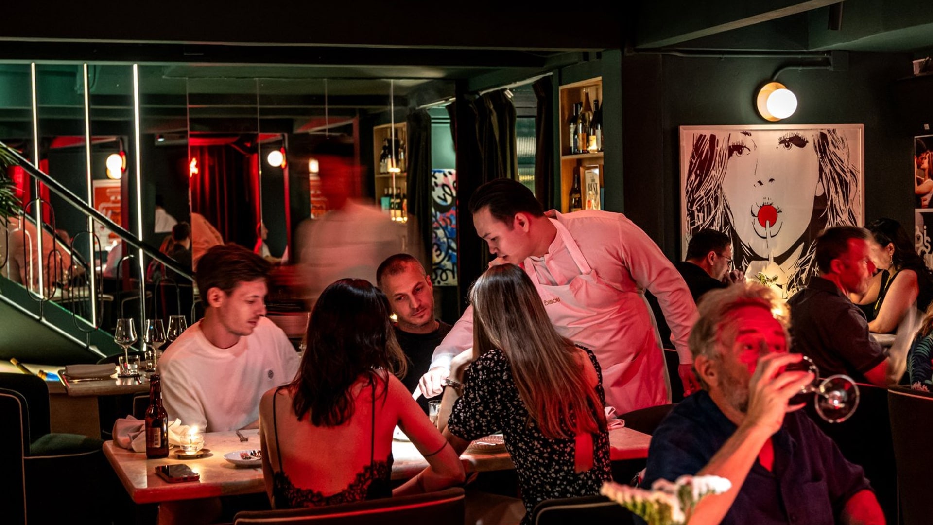 A full dining room late at night at Bisou, a modern French restaurant on Soi Langsuan, Bangkok