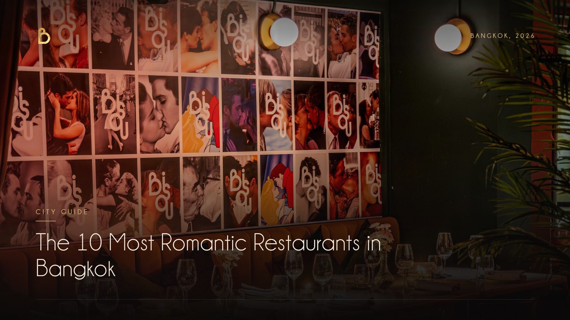 Candlelit tables in front of the kiss wall at Bisou, a modern French restaurant on Soi Langsuan in Bangkok