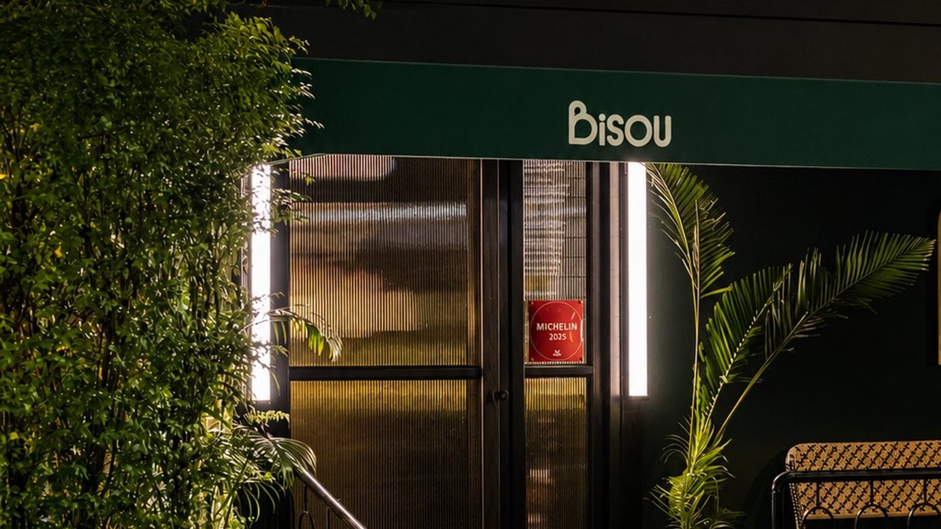 The lit facade of Bisou, a modern French restaurant on Soi Langsuan 9, Lumphini, Bangkok
